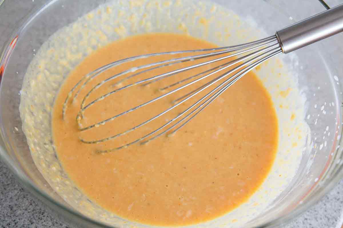mixing in wet ingredients for pumpkin waffle mix