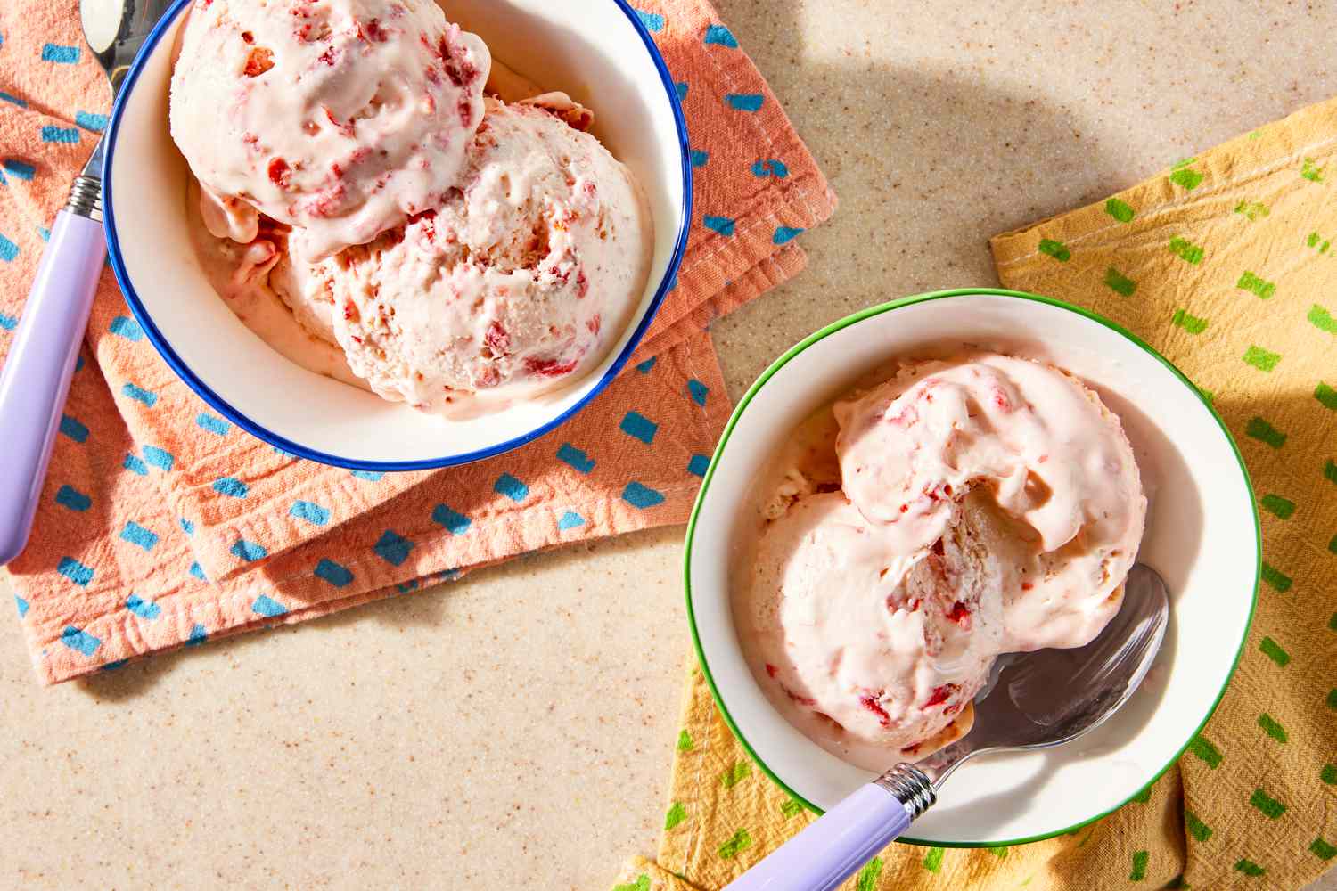 strawberry marlow in two bowls next to table napkins and spoons
