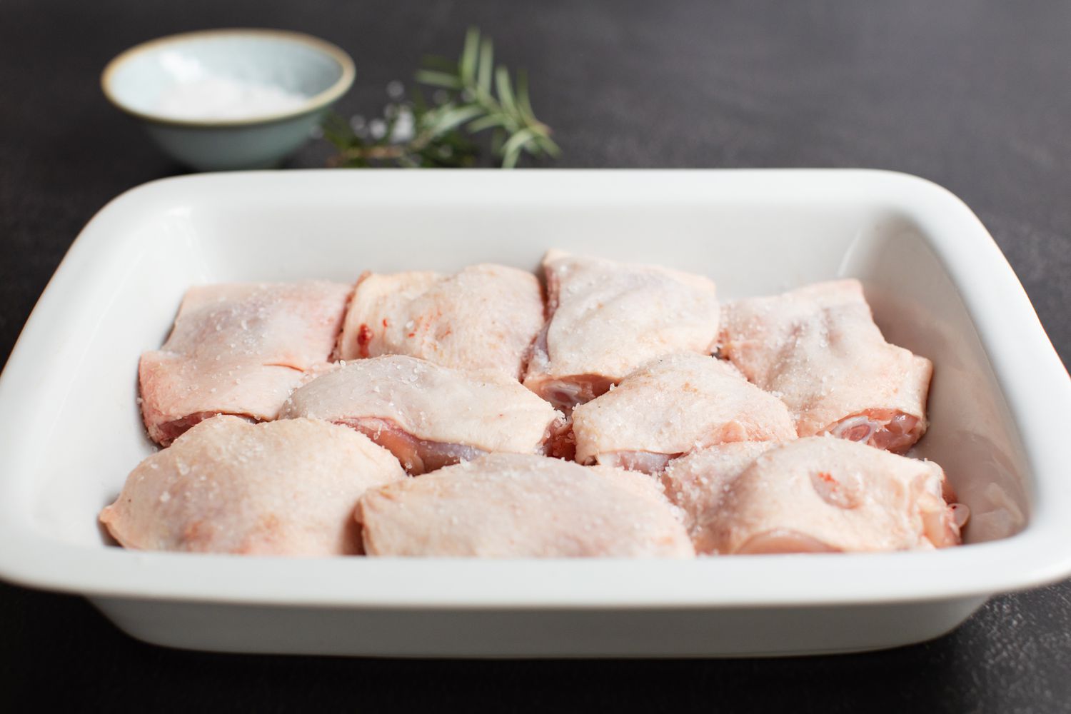 Chicken thighs in a casserole dish ready to be baked.