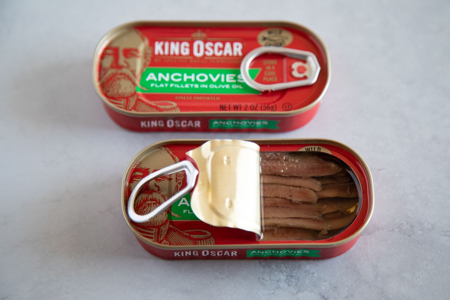 Can of King Oscar anchovies, one open and one sealed