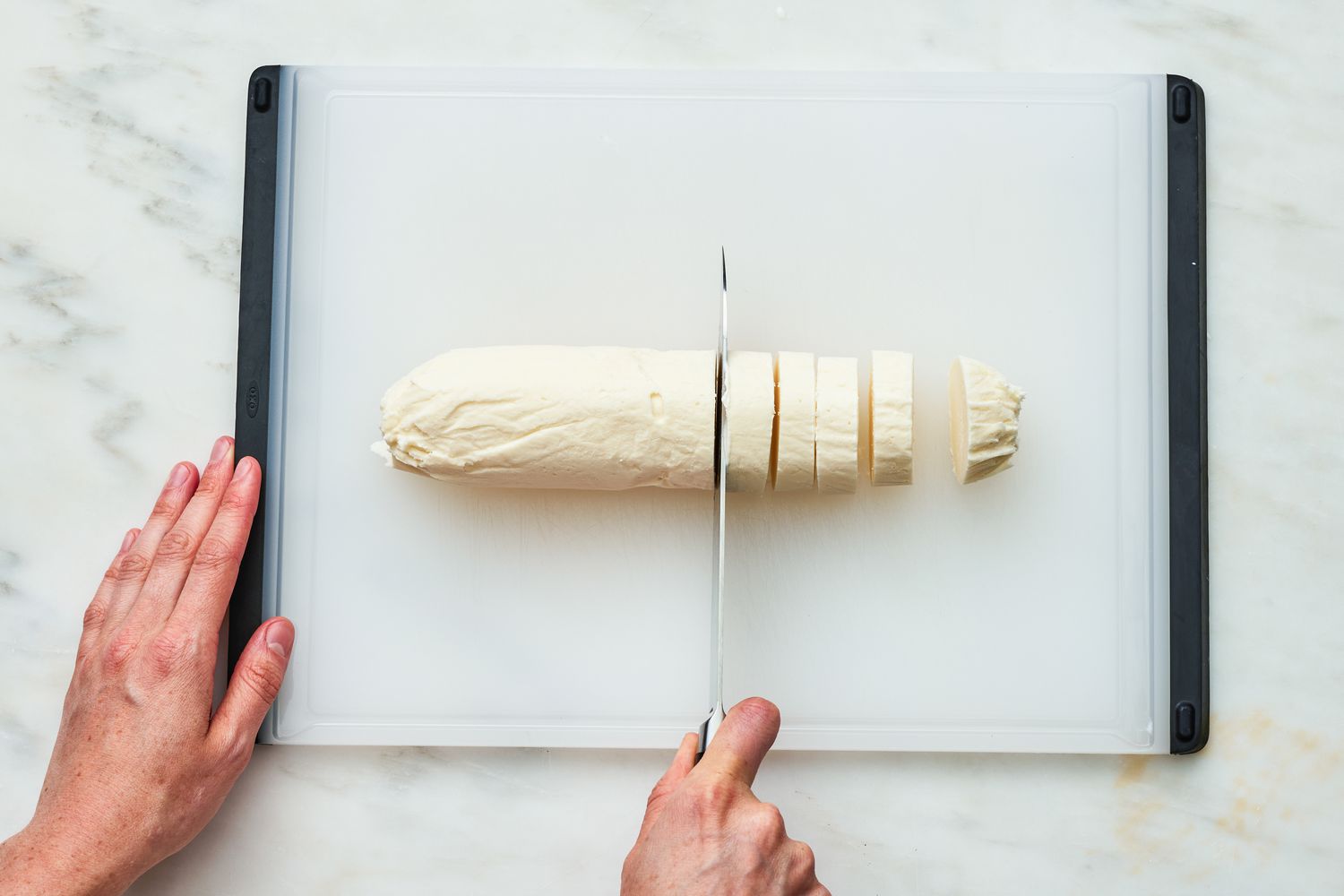 Log of Vanilla Ice Cream on a Cutting Board and Cut Into Slices for Oreo Ice Cream Sandwich Recipe