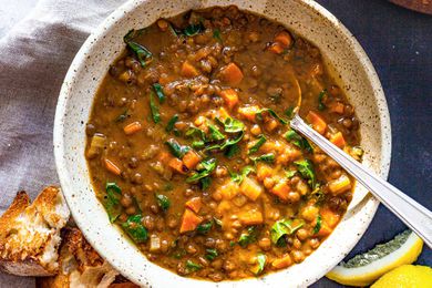 Vegetable Lentil Soup in a bowl with a spoons.