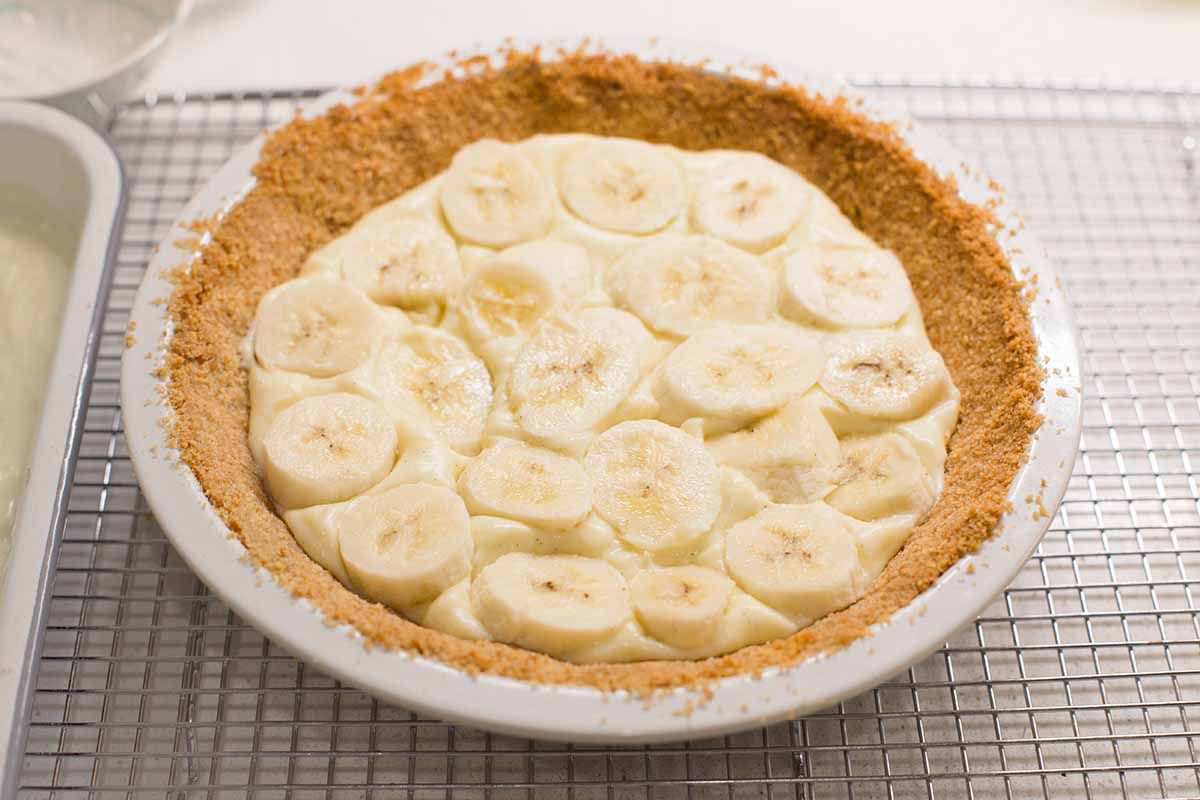 Homemade Banana Cream Pie with banana slices layered ontop of the pudding in a vanilla waffer crust.