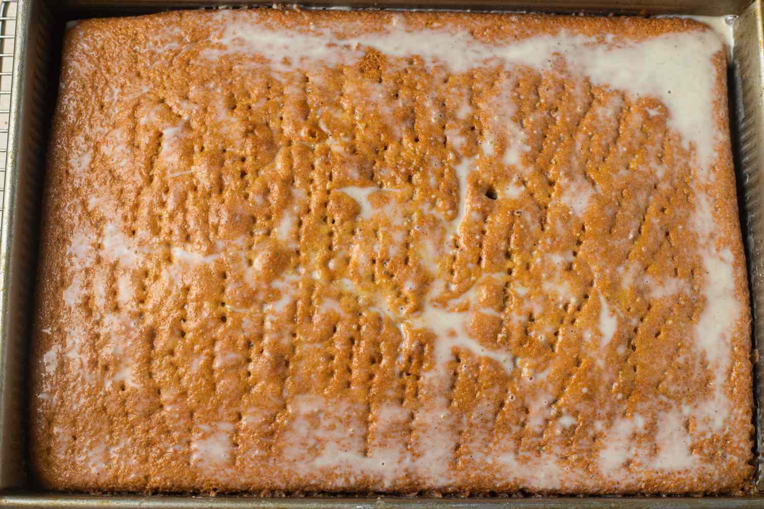 Milk Mixture Poured onto Pistachio Cardamom Tres Leches Cake