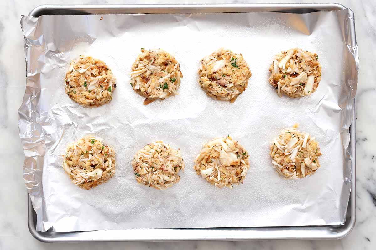 Eight Maryland Crabcakes on a sheetpan lined with aluminum foil