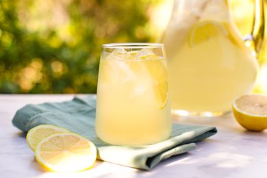 A glass and pitcher of lemonade from scratch