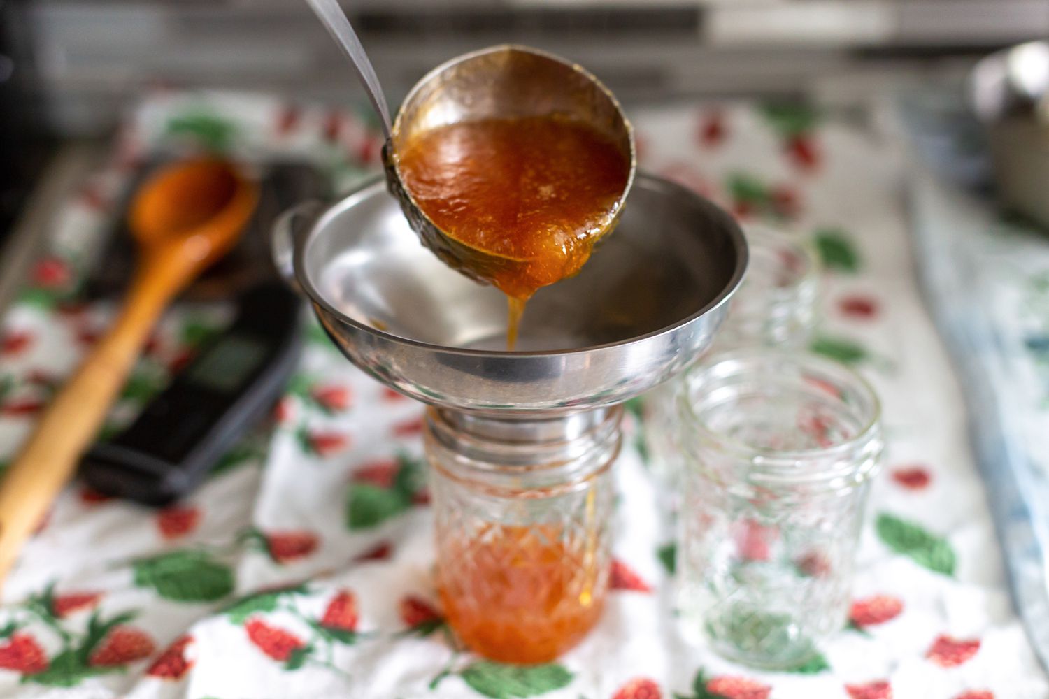 Peach and Pineapple Jam Ladled into the Funnel for Canning