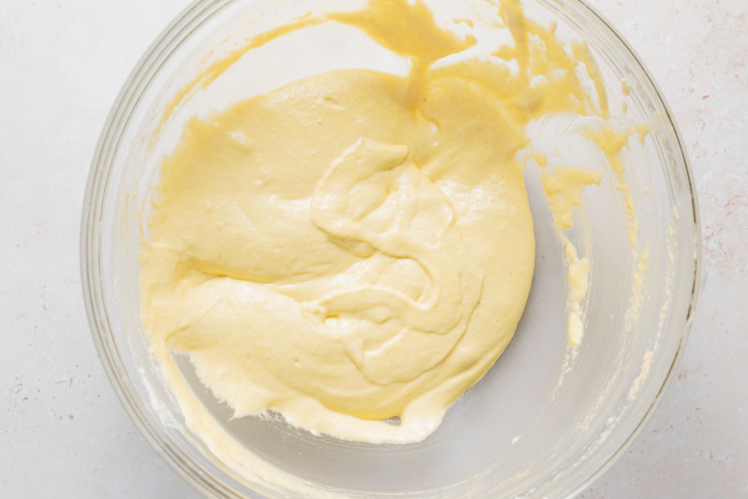 Doing the figure 8 test on lemon buttercream macaron batter.