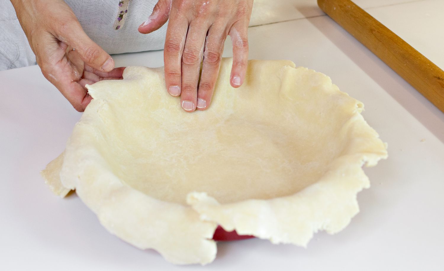 Handmade Pie Dough Carefully Pressed Down to Line the Bottom and Sides of the Pie Dish