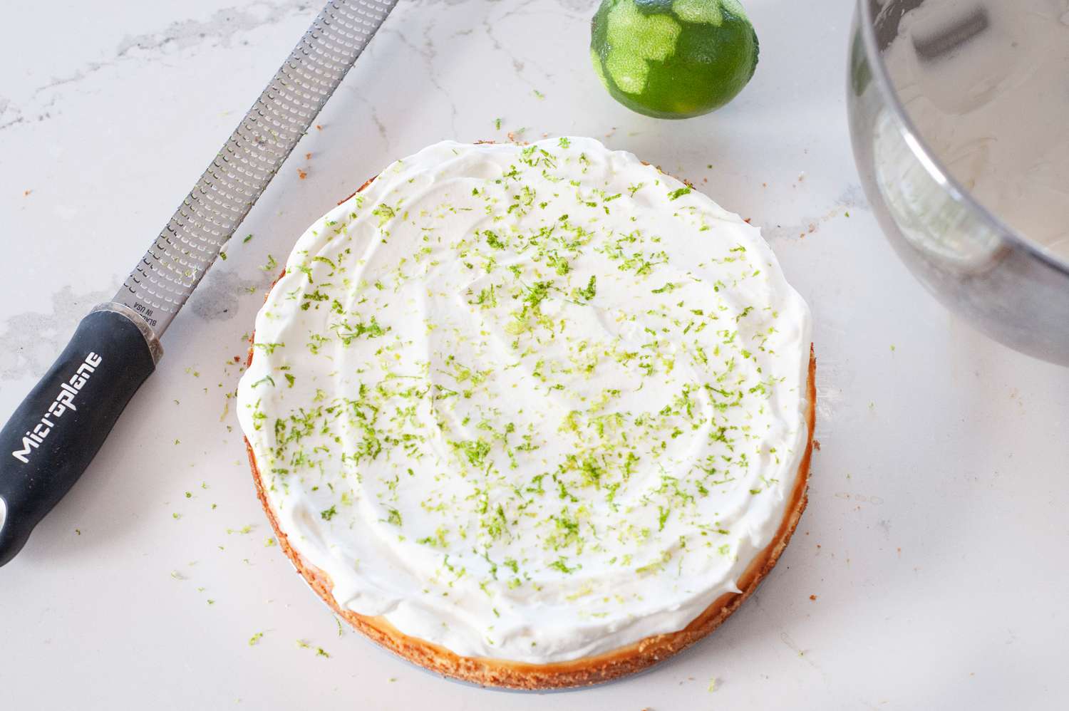 Key lime cheesecake topped with key lime zest.