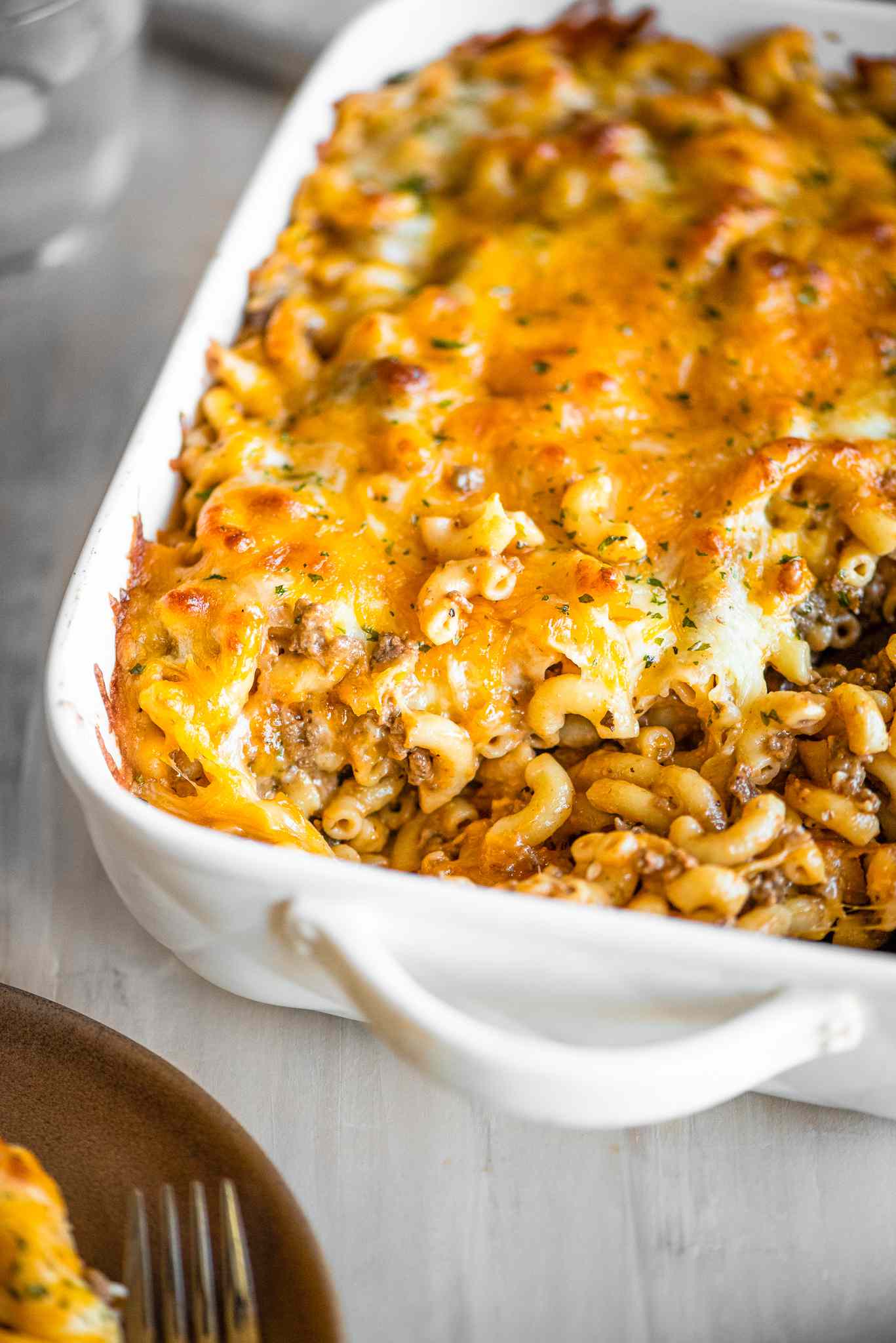 Casserole Dish of Cheeseburger Casserole with a Serving Already Served 