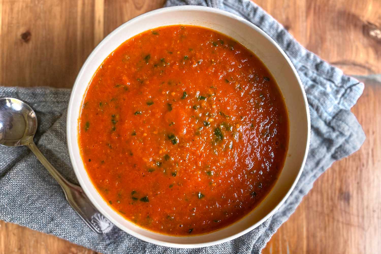 A bowl of bright red tomato soup