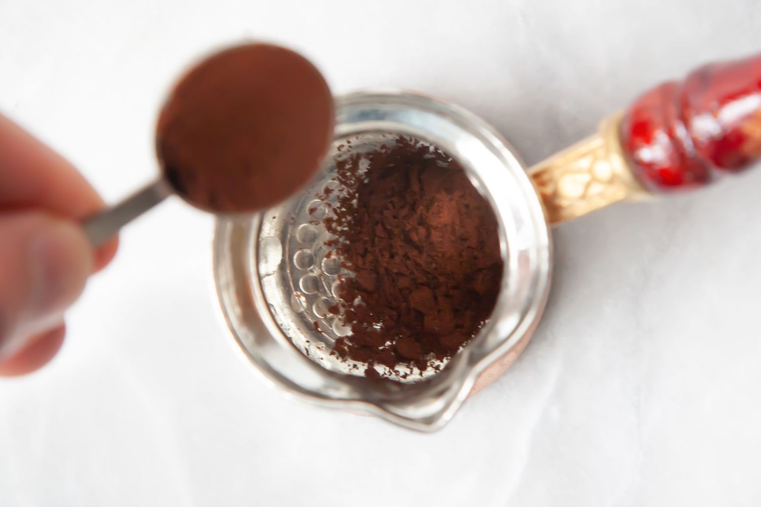 Turkish Coffee Grounds Spooned into Cezve for How to Make Turkish Coffee