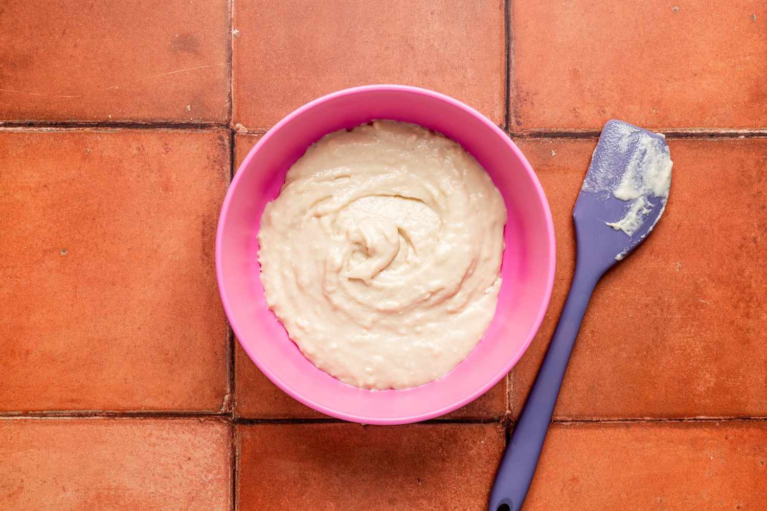 Bowl of pan de muerto starter next to a small spatula