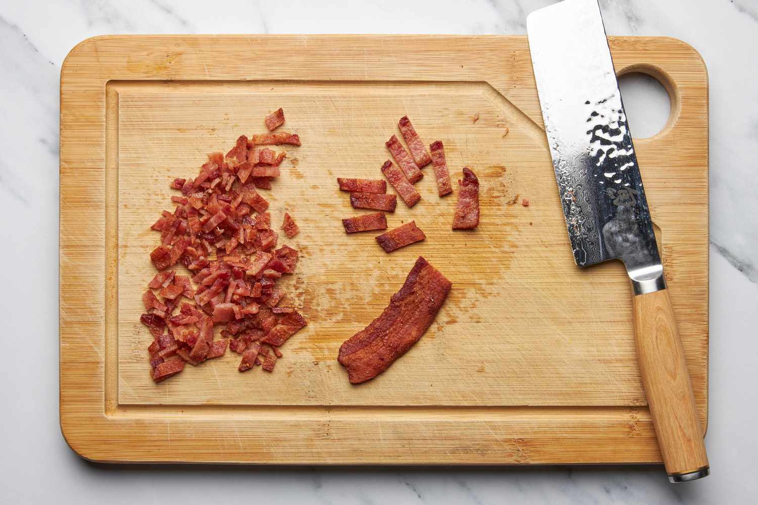 Bacon cut into small slices on a cutting board for jalapeÃ±o popper grilled cheese recipe
