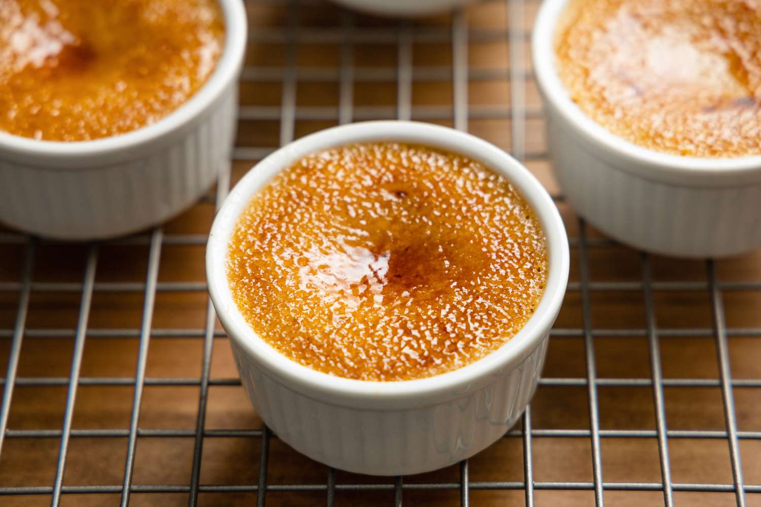 Ramekins of 3-Ingredient Pumpkin Spice Crème Brûlée Cooling on Wire Rack