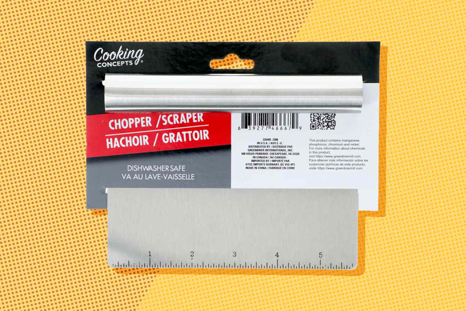 A kitchen chopper scraper tool in packaging with measurement markings on the blade
