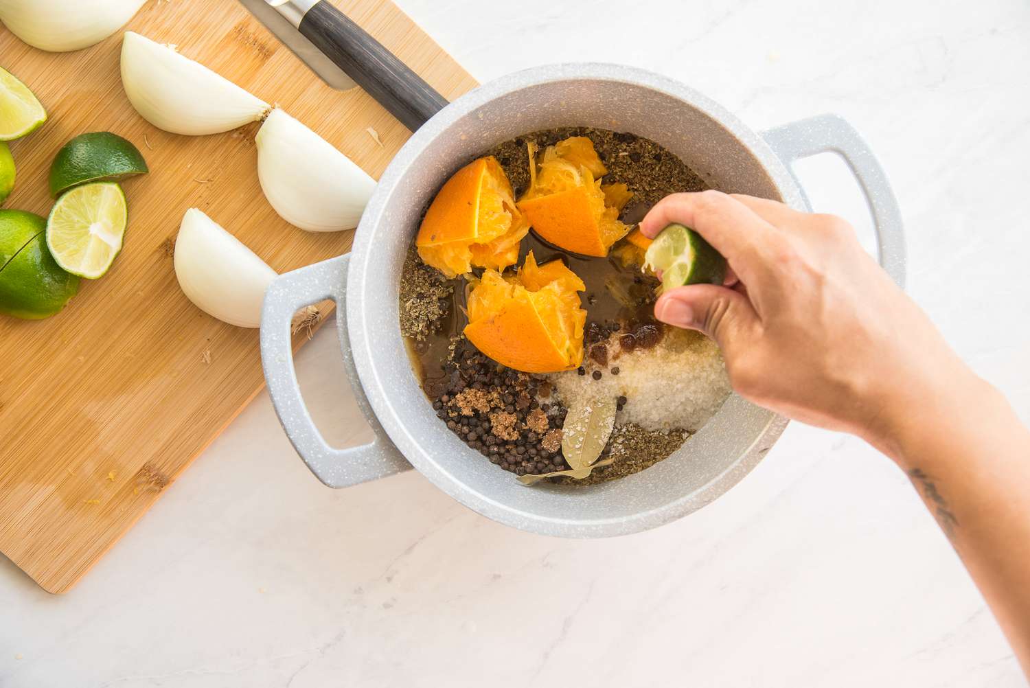 Orange, Limes, and Onions Added to Pot for Pork Chop Brine