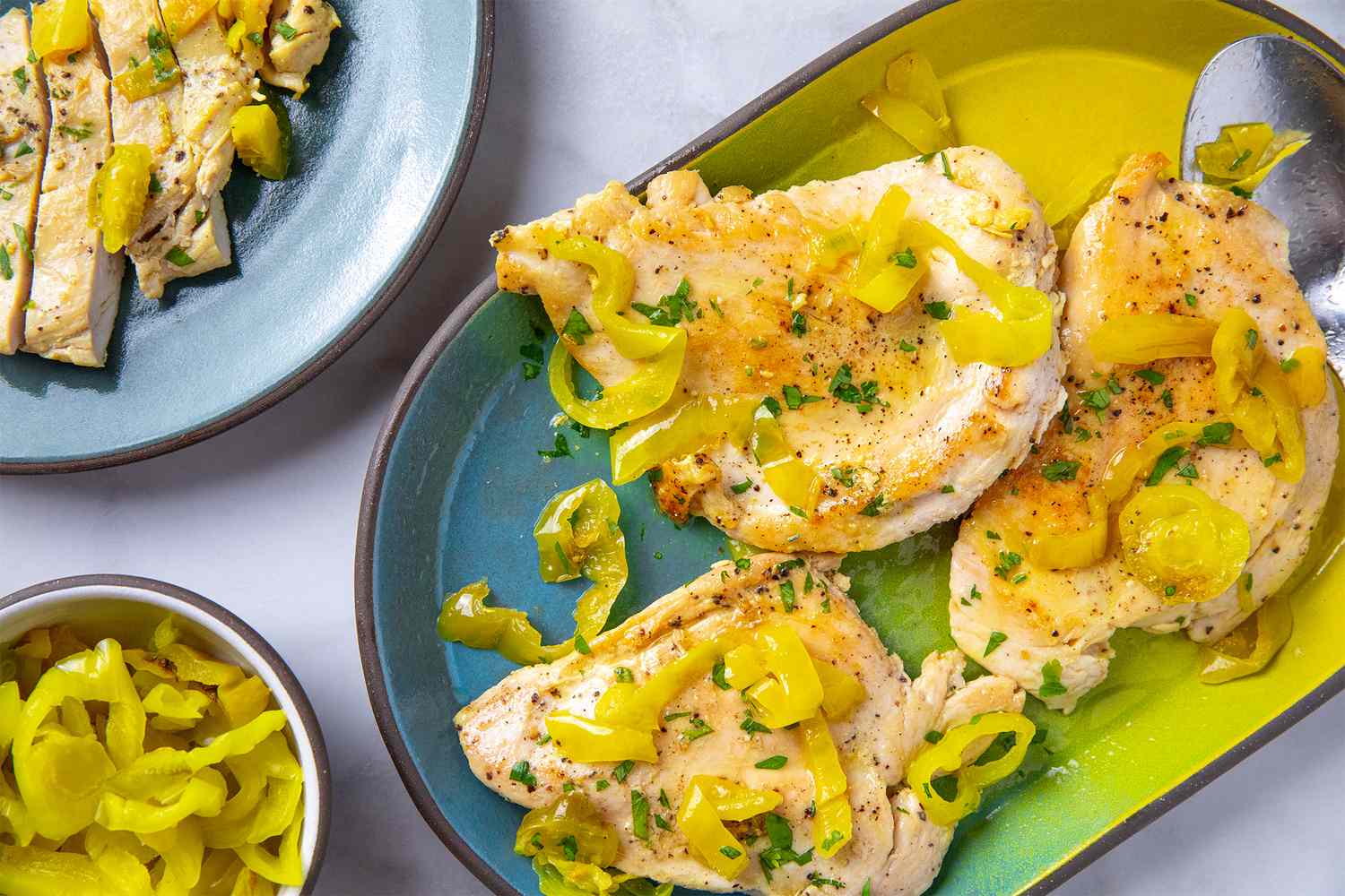 Grilled chicken breast with banana pepper slices served on a plate