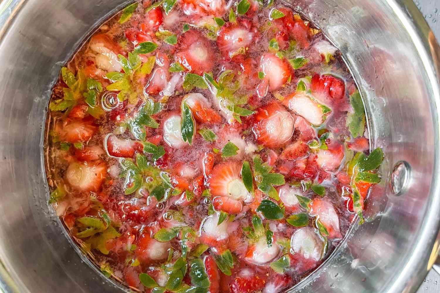 Strawberry Tops in a Pot With Sugar and Water 