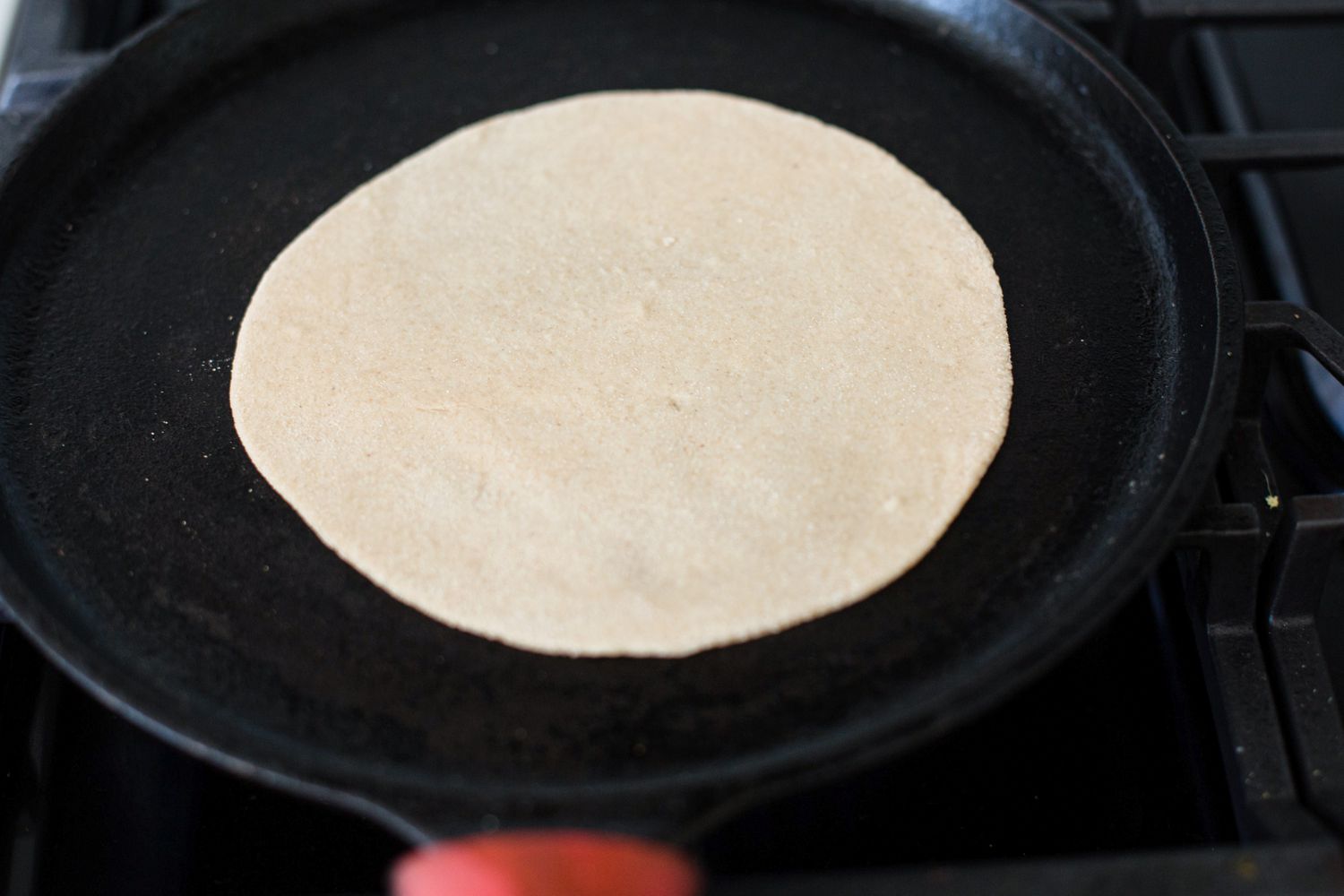 Showing how to make roti on the stovetop.