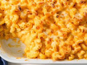 Overhead view of baked macaroni and cheese with a serving removed
