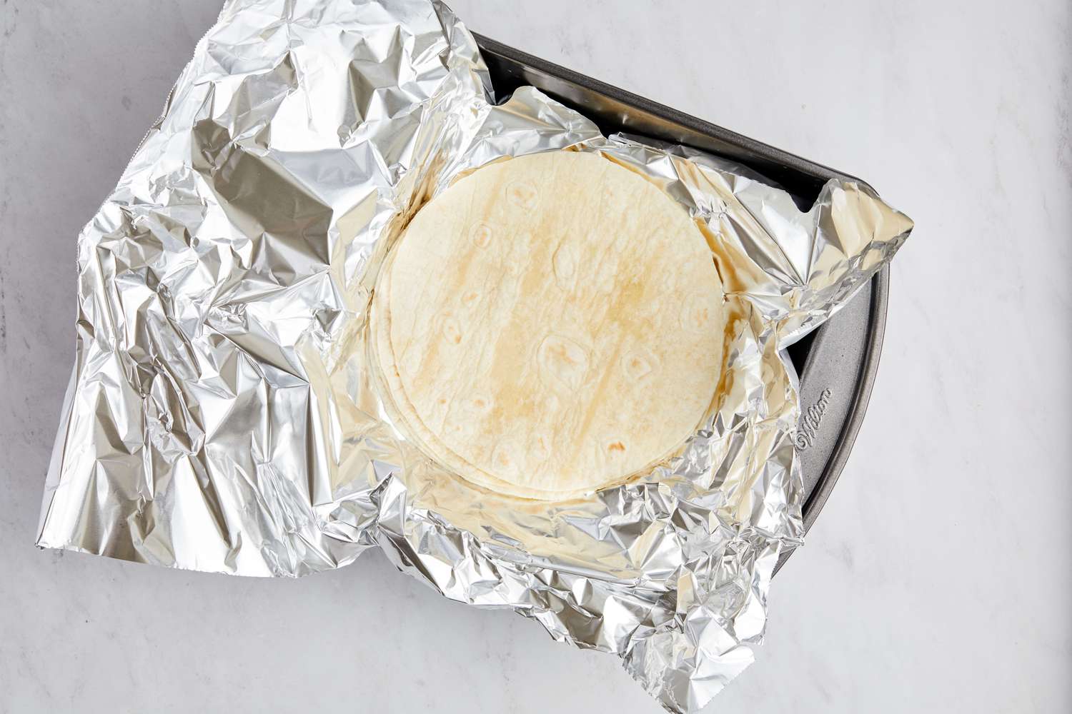 Tortillas for Blackened Shrimp Tacos on Foil in a Baking Pan