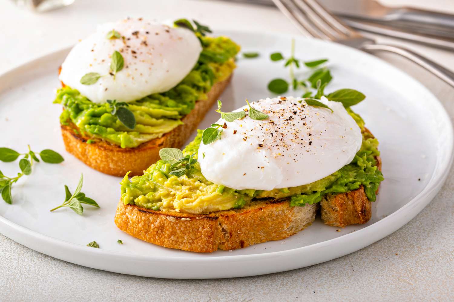Avocado toast with a perfect poached egg on top with salt and pepper