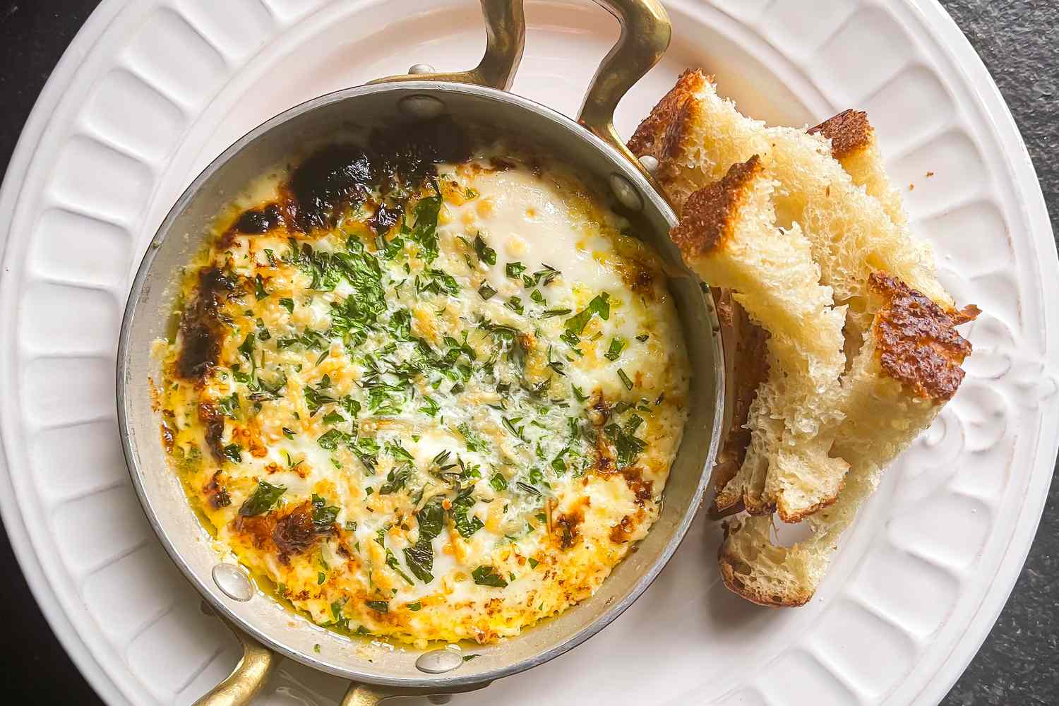 Ina Garten's Herbed Baked Eggs with crusty bread pieces