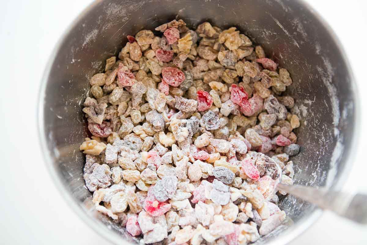 Toss the dried fruits for the fruitcake with a little flour