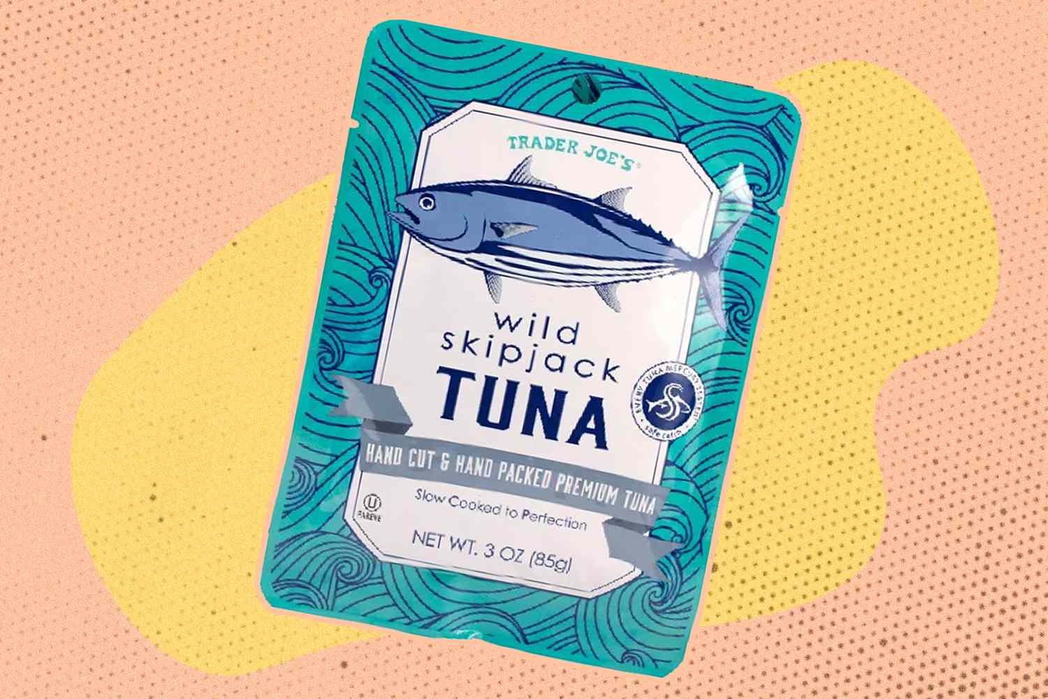 Trader Joe's Wild Skipjack Tuna packet with a yellow and peach color blob background