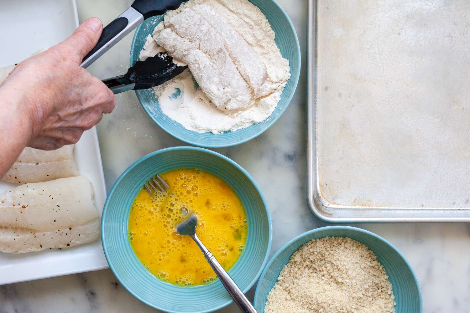 Fish fillets coated with flour to make Fish Sandwiches with Avocado Mayo.
