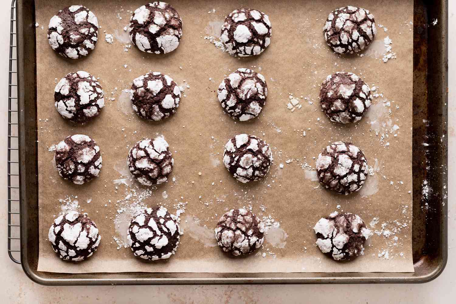 A baked sheet of chocolate crackle cookies.