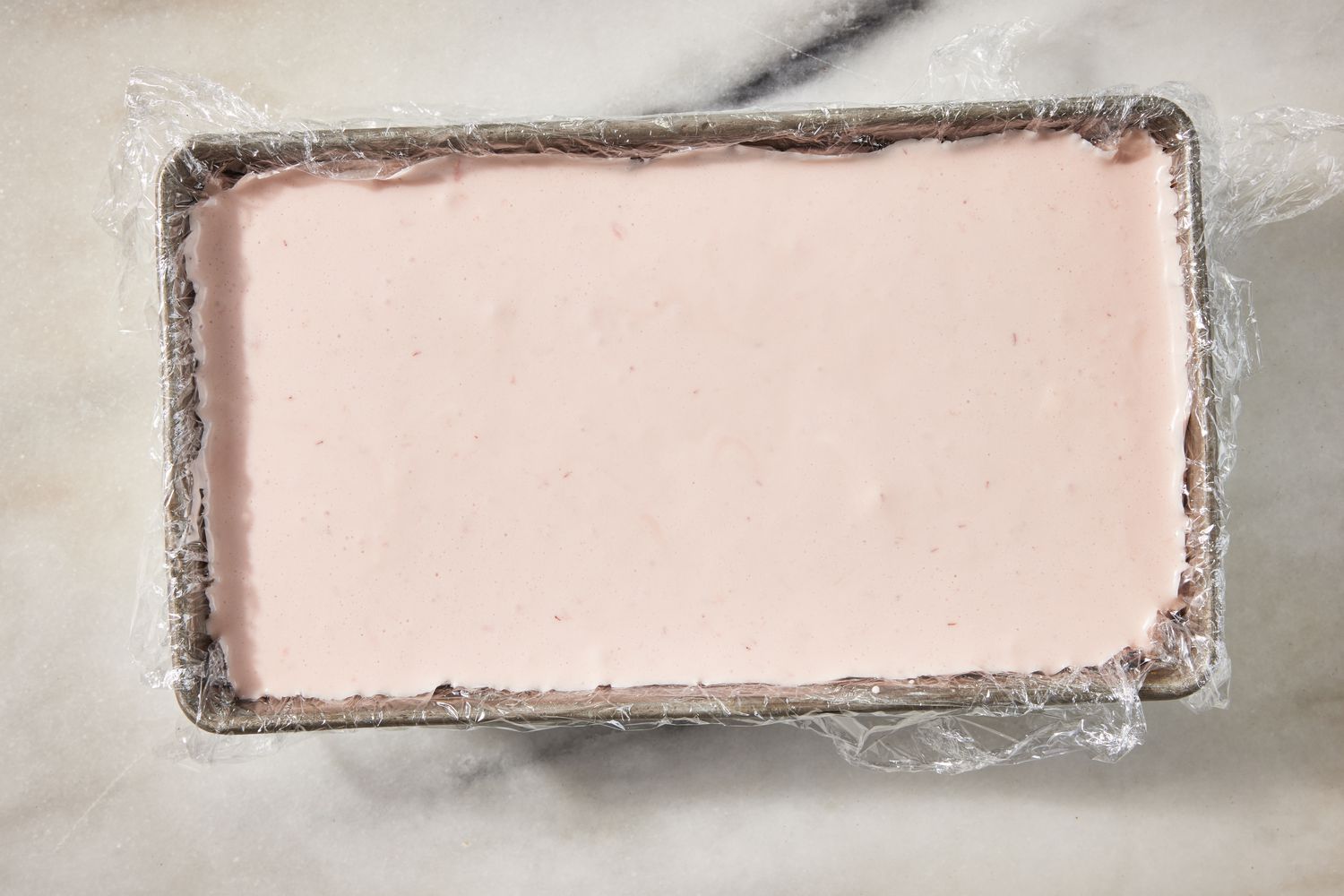 strawberry marlow added to plastic covered loaf pan