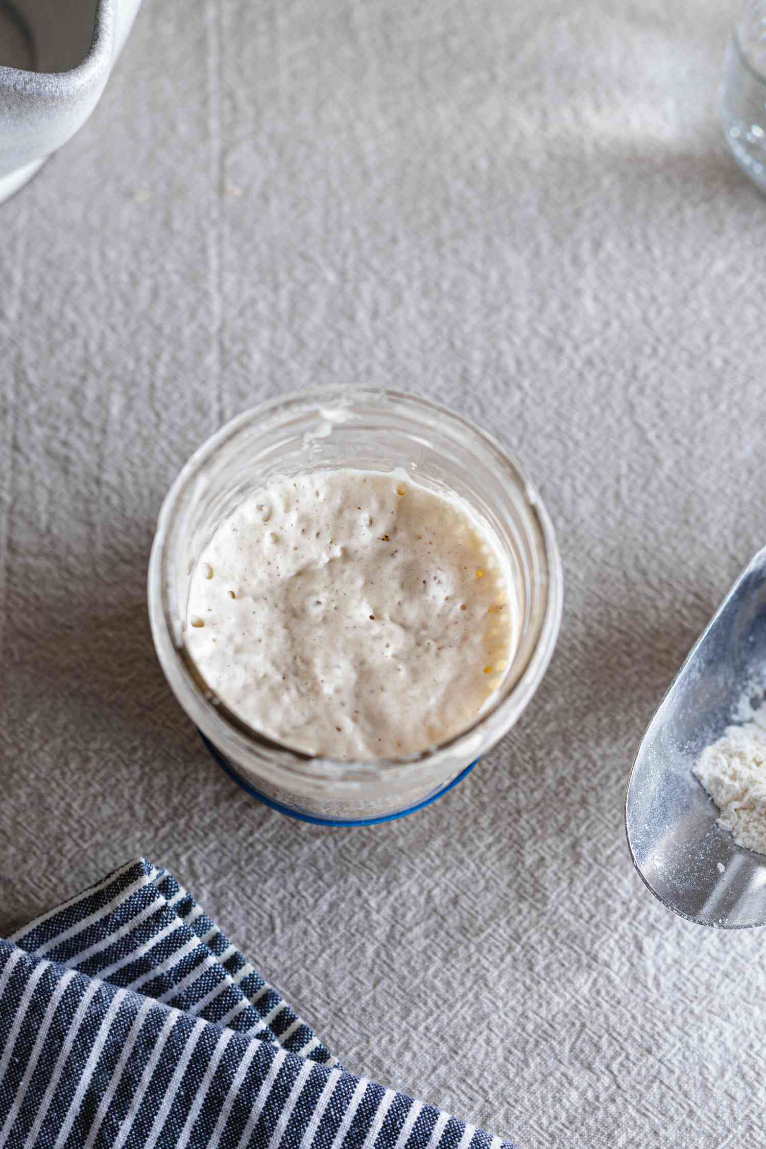 Overhead view of a simple sourdough starter in a mason jar..