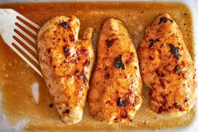 Overhead shot of three marinated and cooked chicken breasts