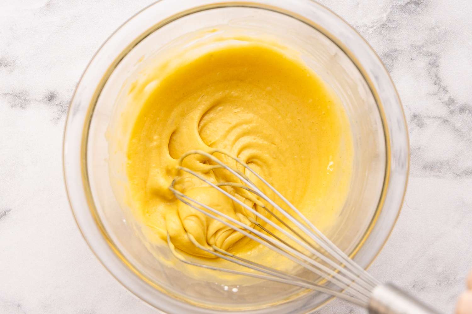 Yolk and Other Ingredients Whisked Together in a Bowl for Japanese Pancakes Batter