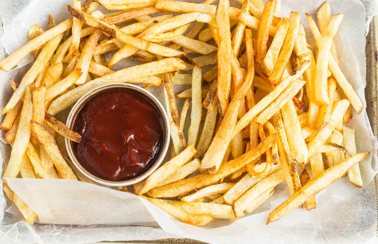 Tray of Homemade French Fries Served with a Bowl of Ketchup