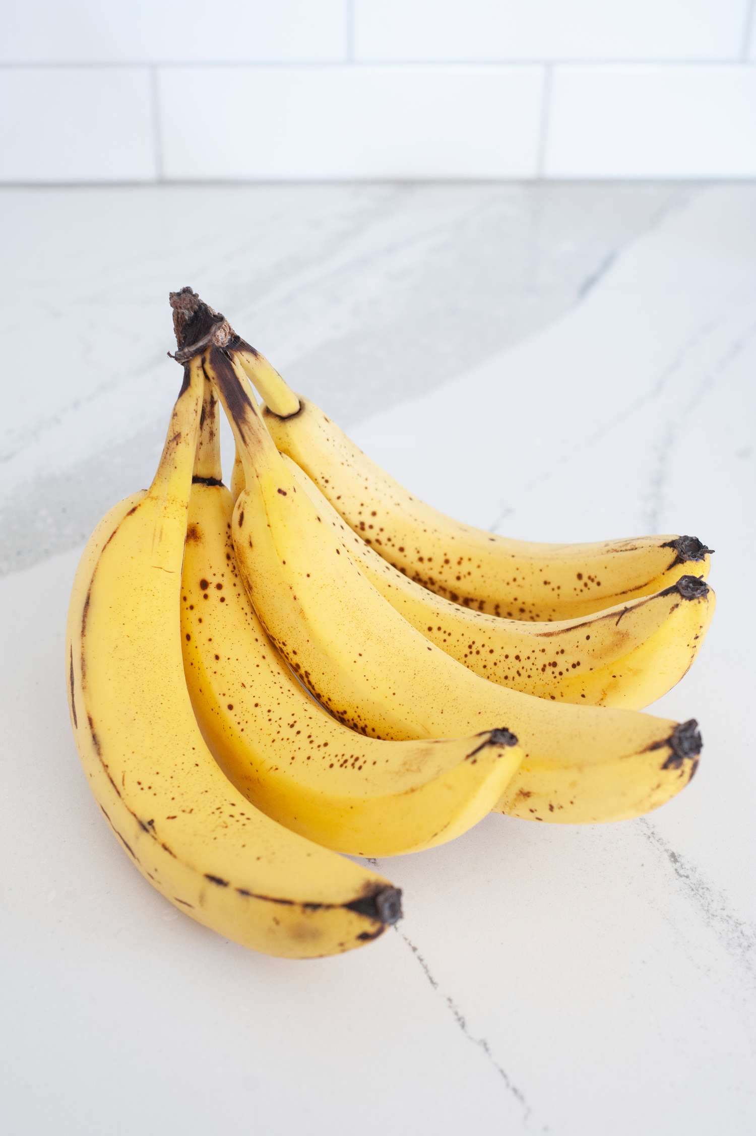 Bunch of bananas on a white countertop