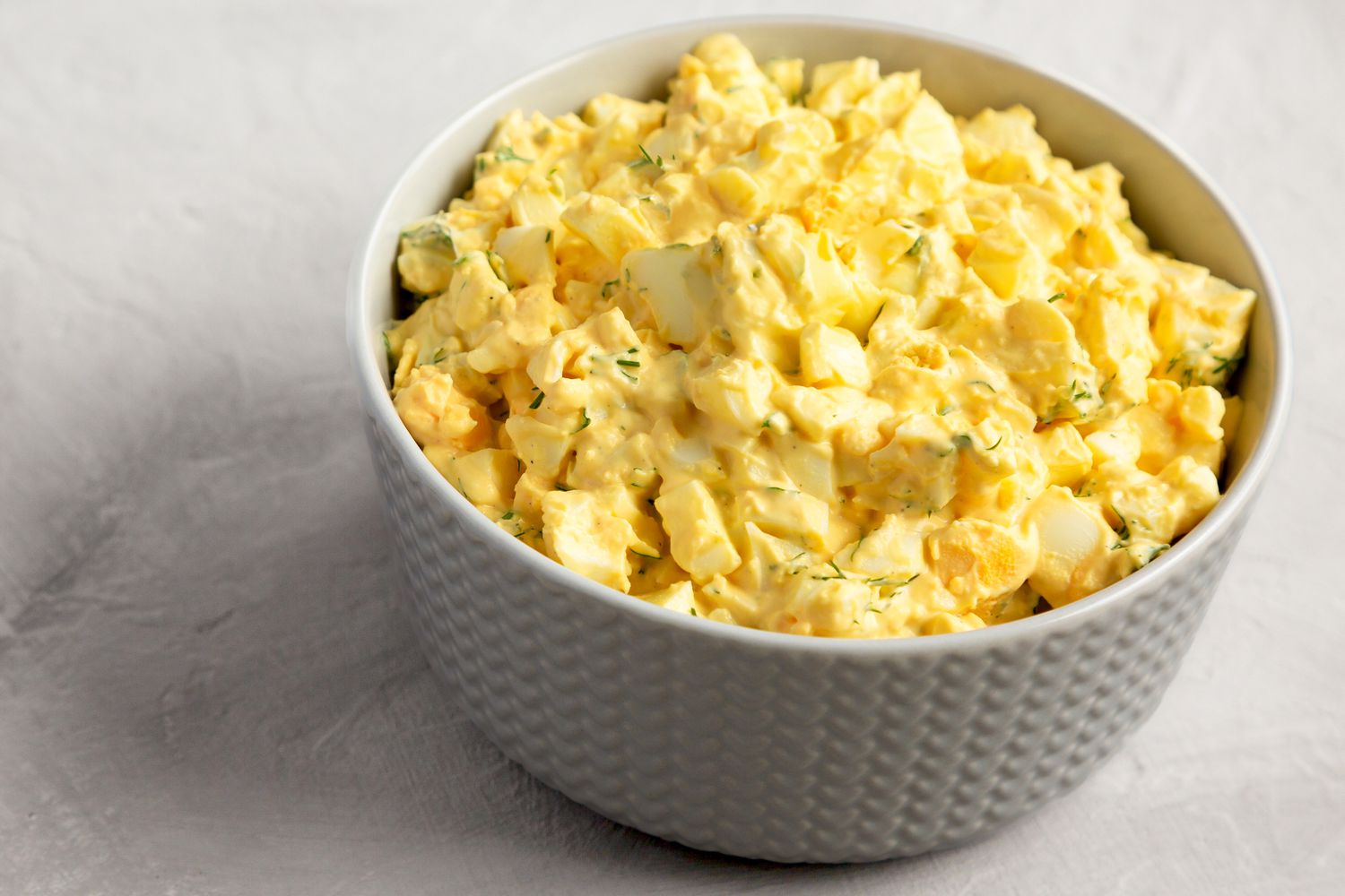 Closeup of creamy egg salad in a bowl