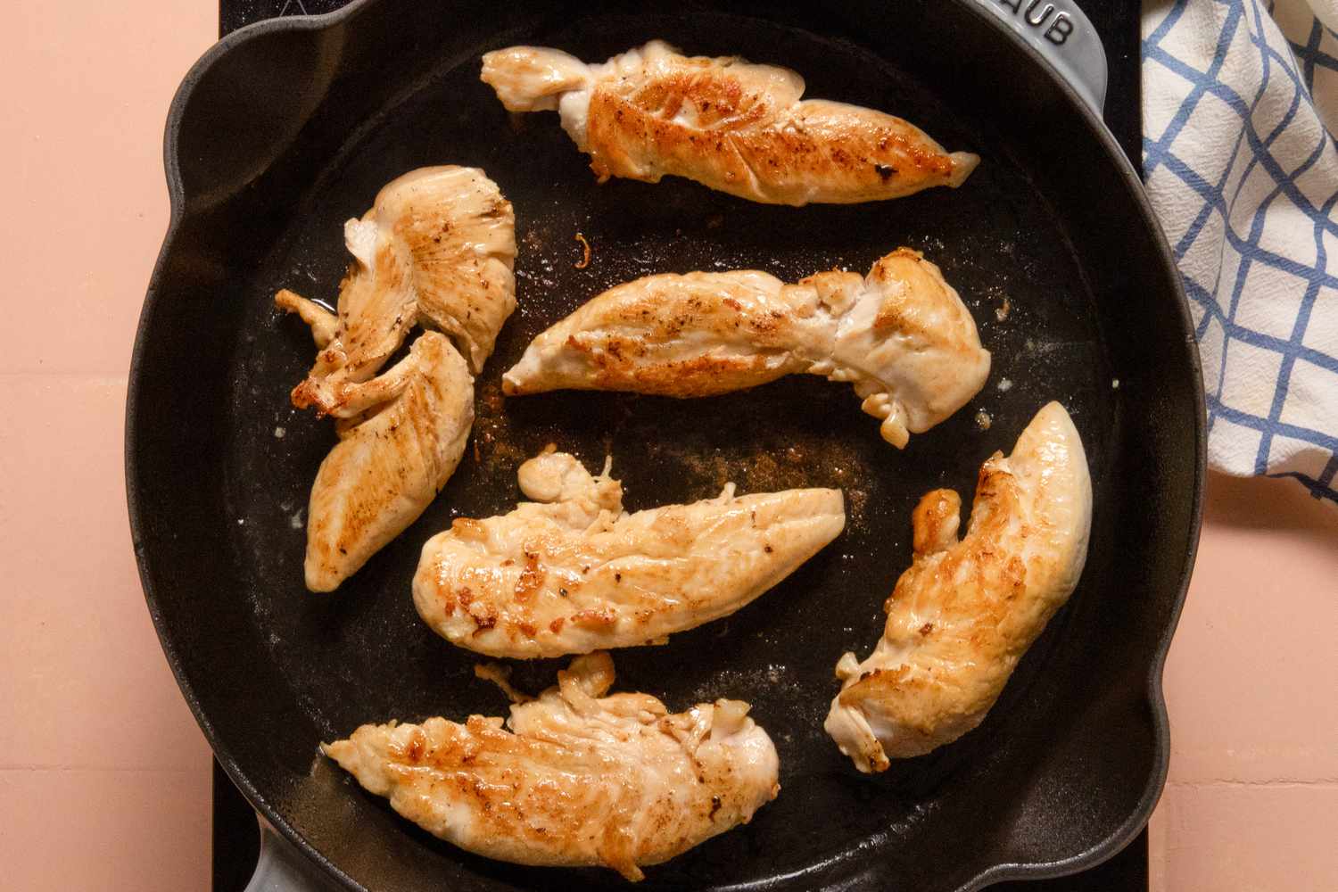 chicken tenderloins cooking in a skillet for french onion chicken recipe