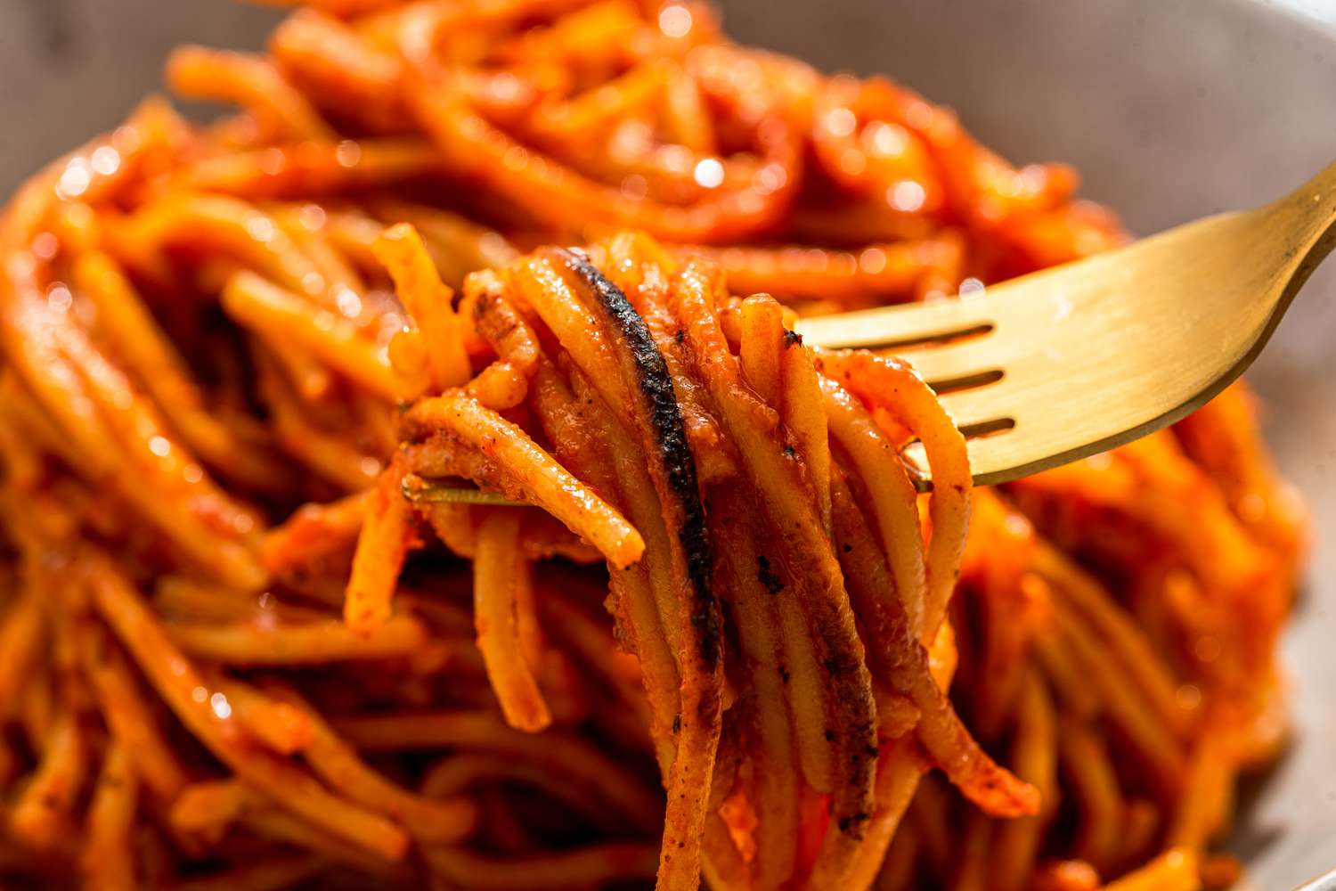 Assassin's spaghetti lifted from a bowl using a fork
