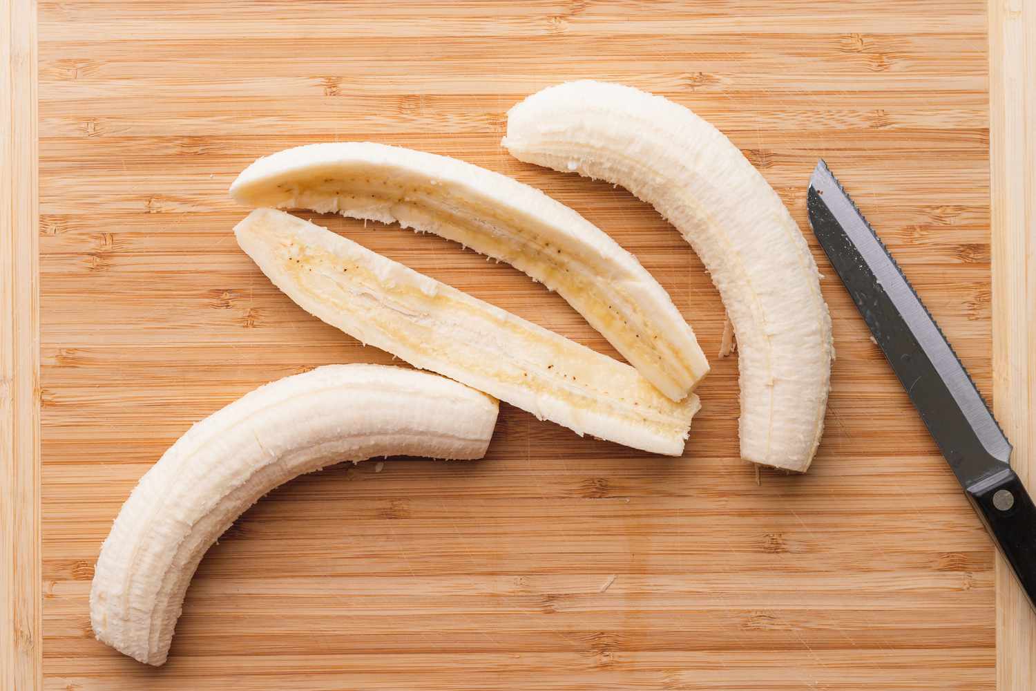 Bananas Cut in Half on a Cutting Board for Foster Recipe