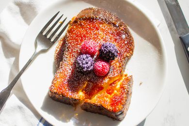 creme brulee french toast topped with berries and powdered sugar