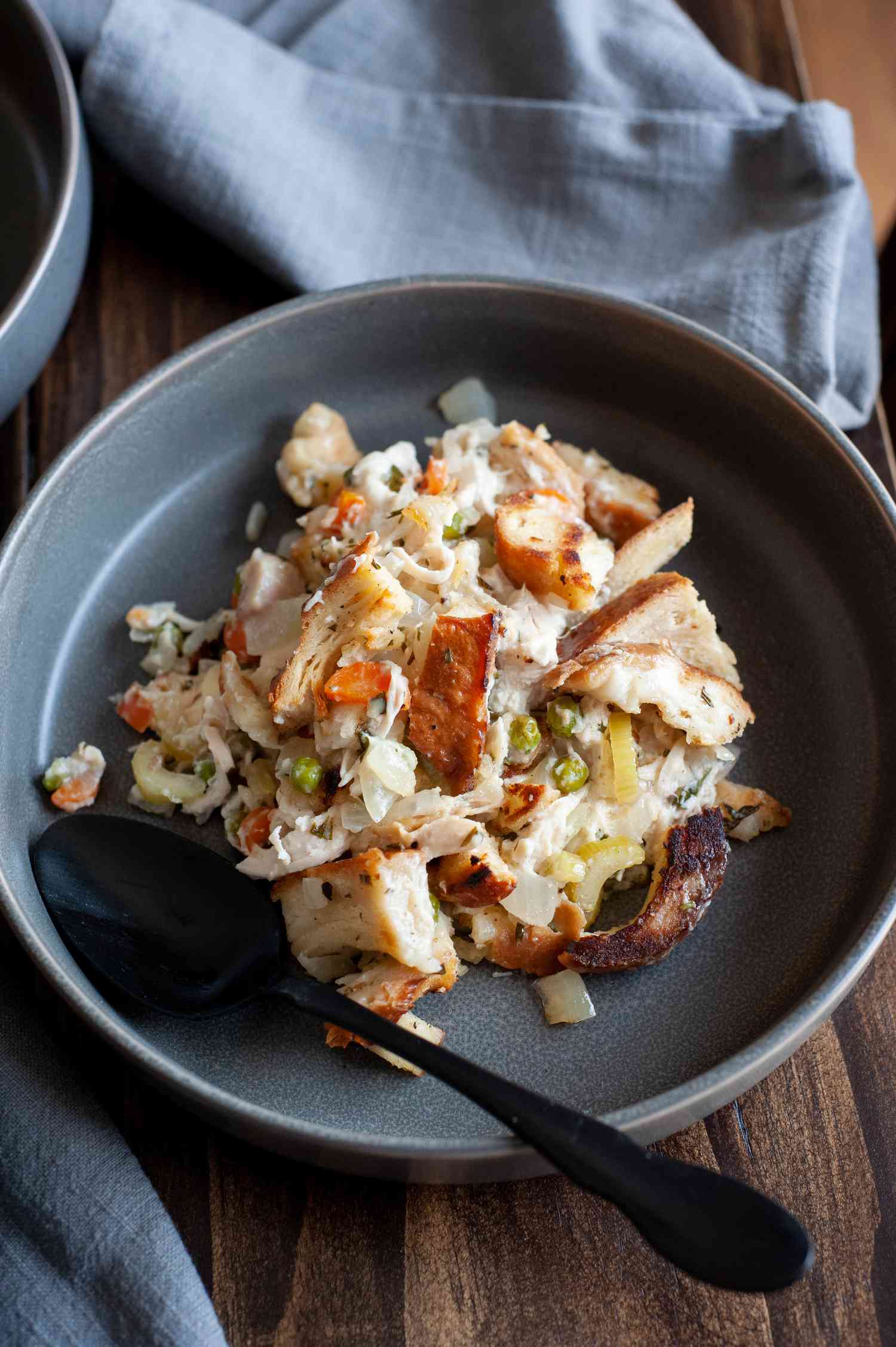 Chicken stuffing casserole in black bowl.