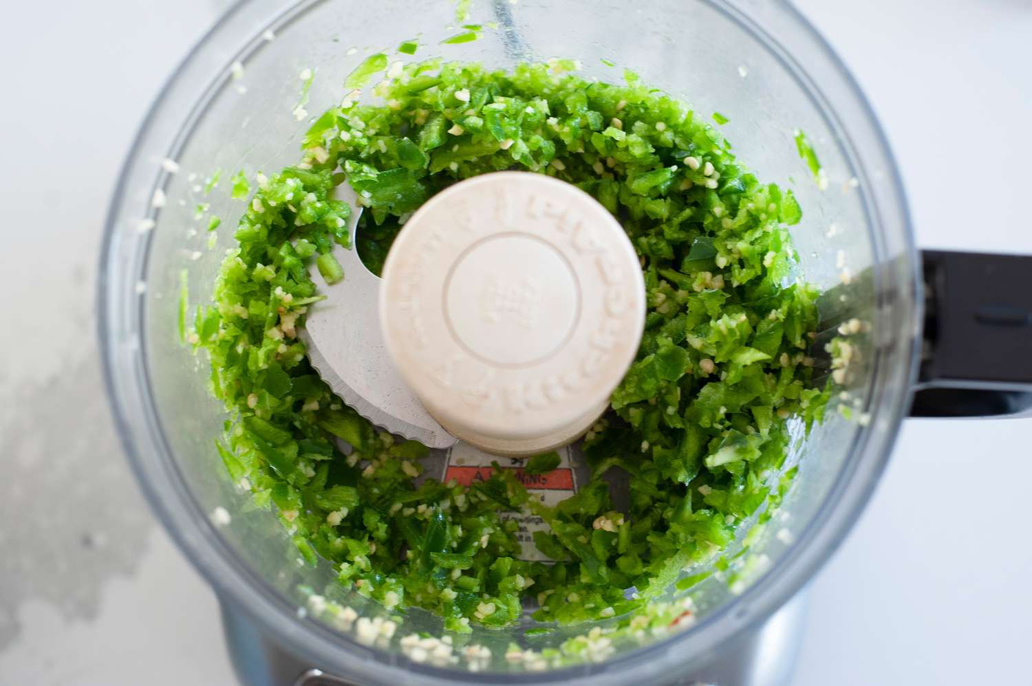 Jalapeños and garlic in food processor.