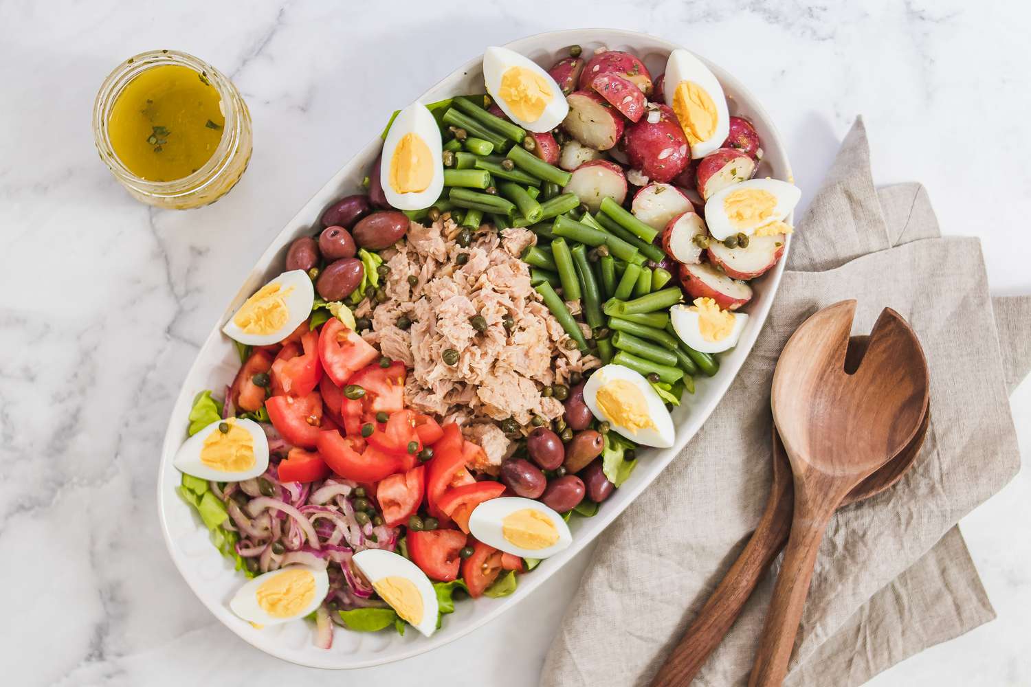 Overhead view of a platter of nicoise salad.