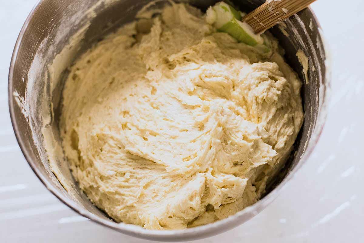 Dough to make homemade sugar cookies in a mixing bowl.