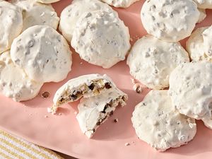 A plate of forgotten cookies with one broken in half to show the inside