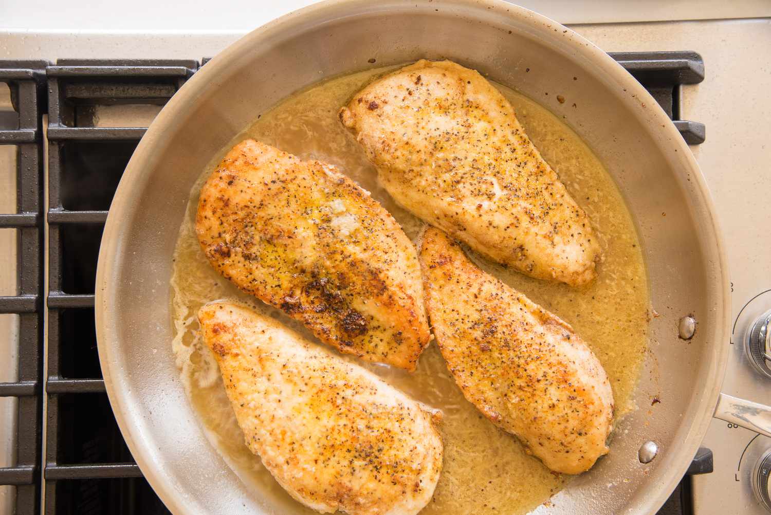 Pan of Lemon Pepper Chicken with Sauce on a Stove 